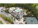 Aerial view of the community pool, featuring a water park, a lap pool, and tennis courts at 8208 Bella Oak Ct, Wake Forest, NC 27587