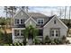 Beautiful home featuring a welcoming front porch with vine archway, lush lawn, and lovely landscaping at 8208 Bella Oak Ct, Wake Forest, NC 27587