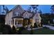 Stunning two-story home featuring a well-manicured front yard and inviting front porch with manicured shrubs and trees at 8208 Bella Oak Ct, Wake Forest, NC 27587