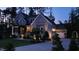 Beautifully lit home exterior at twilight with a landscaped yard and inviting entrance at 8208 Bella Oak Ct, Wake Forest, NC 27587