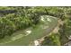 Aerial view of the expansive golf course with mature trees, strategically placed sand traps, and undulating greens at 8208 Bella Oak Ct, Wake Forest, NC 27587