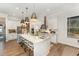 Bright kitchen features a spacious island, stainless steel appliances, and stylish pendant lighting at 8208 Bella Oak Ct, Wake Forest, NC 27587