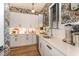 An expansive butler's pantry featuring white cabinets, stainless steel appliances, modern fixtures, and designer wallpaper at 8208 Bella Oak Ct, Wake Forest, NC 27587