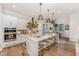 Bright, white kitchen with a large island, stainless steel appliances, and hardwood floors at 8208 Bella Oak Ct, Wake Forest, NC 27587
