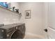 Modern laundry room with front-load washer and dryer, and storage shelf at 8208 Bella Oak Ct, Wake Forest, NC 27587