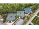 Aerial view of well-maintained tennis courts surrounded by lush greenery and a convenient parking area at 8208 Bella Oak Ct, Wake Forest, NC 27587
