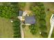 Aerial view of a house with a pool, trees, and green lawns at 905 Tyler Ct, Garner, NC 27529