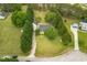 Aerial view of a house with a long driveway, trees, and green lawns at 905 Tyler Ct, Garner, NC 27529