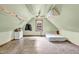 Finished attic features neutral paint, vinyl flooring and window at 905 Tyler Ct, Garner, NC 27529