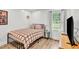Cozy bedroom with a full-sized bed, hardwood floors, and natural light at 905 Tyler Ct, Garner, NC 27529
