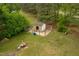 Aerial view of a backyard chicken coop with a small wooden structure and fenced-in area at 905 Tyler Ct, Garner, NC 27529