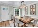 Dining area features a wooden table, modern light fixture, and view to the backyard at 905 Tyler Ct, Garner, NC 27529