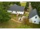 Aerial view of a white house with a dark roof, wooden deck, and green landscaping at 905 Tyler Ct, Garner, NC 27529