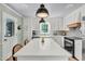 Bright kitchen with white cabinets, a large island, and modern appliances at 905 Tyler Ct, Garner, NC 27529