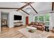 Well-lit living room showcasing hardwood floors, exposed beams, and stylish furnishings at 905 Tyler Ct, Garner, NC 27529