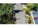 Birds-eye view of the property, revealing the layout of the house, driveway, and the mature trees surrounding it at 918 Albany Ct, Raleigh, NC 27615