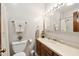 Bright bathroom featuring a vanity with white countertops and wooden cabinets with a shower at 918 Albany Ct, Raleigh, NC 27615