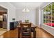 Bright dining room features hardwood floors, large windows, and stylish chandelier at 918 Albany Ct, Raleigh, NC 27615
