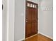 Elegant foyer featuring hardwood floors, coat hooks, and a stylish front door with glass accents at 918 Albany Ct, Raleigh, NC 27615
