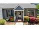 Close-up of the home's entrance, showcasing a well-maintained facade, flowering bushes, and a welcoming front porch at 918 Albany Ct, Raleigh, NC 27615
