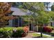 Charming home entrance featuring a covered porch, colorful landscaping, and inviting walkway at 918 Albany Ct, Raleigh, NC 27615