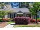 Charming home with beautiful landscaping, including colorful azaleas and mature trees, and covered entrance at 918 Albany Ct, Raleigh, NC 27615