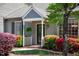 Charming home entrance featuring a covered porch, colorful landscaping, and inviting curb appeal at 918 Albany Ct, Raleigh, NC 27615