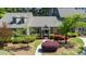 Charming gray two-story home boasts a beautifully landscaped front yard with vibrant azaleas and lush greenery at 918 Albany Ct, Raleigh, NC 27615