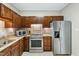 Traditional kitchen features stainless steel appliances, granite countertops, and wood cabinets at 918 Albany Ct, Raleigh, NC 27615