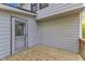 Back porch with door and wood floors overlooking the wooded yard at 924 Lynn Rd, Durham, NC 27703