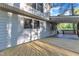 Rear covered porch overlooking yard with wood deck and access door at 924 Lynn Rd, Durham, NC 27703