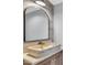 Updated powder room with stone sink, modern finishes and large mirror at 924 Lynn Rd, Durham, NC 27703