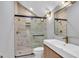 Bathroom with vanity, toilet, and a frameless glass shower featuring designer tile at 924 Lynn Rd, Durham, NC 27703