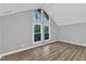 Vaulted bedroom offering wood-look floors and multiple windows for natural light at 924 Lynn Rd, Durham, NC 27703