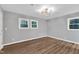 Empty bedroom with new flooring and three windows at 924 Lynn Rd, Durham, NC 27703