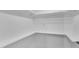 All-white walk-in closet offering shelving and clothing rod for optimal storage at 924 Lynn Rd, Durham, NC 27703