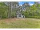 Scenic view of the light blue home nestled in a wooded lot, with a large front yard at 924 Lynn Rd, Durham, NC 27703