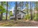 Two-story home surrounded by mature trees offers a wooden deck and beautiful natural light at 924 Lynn Rd, Durham, NC 27703