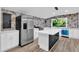 The remodeled kitchen boasts modern appliances, a large island and scenic views at 924 Lynn Rd, Durham, NC 27703