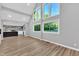 Bright, open-concept living space with large windows, modern flooring, and a view into the adjacent kitchen at 924 Lynn Rd, Durham, NC 27703
