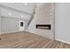 Spacious living area featuring sleek flooring, a modern fireplace, and a staircase leading to the upper level at 924 Lynn Rd, Durham, NC 27703