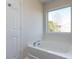 Bright bathroom features a soaking tub beneath a large window offering natural light at 929 Mailwood Dr, Knightdale, NC 27545