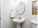 Modern bathroom with pedestal sink, framed mirror and decorative towel ring at 929 Mailwood Dr, Knightdale, NC 27545