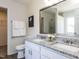 Beautiful bathroom with double granite vanity, granite countertops and large framed mirror at 929 Mailwood Dr, Knightdale, NC 27545