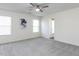 Large bedroom with neutral carpeting, ceiling fan and bright light from large windows at 929 Mailwood Dr, Knightdale, NC 27545