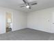 Spacious bedroom featuring ceiling fan, neutral carpet, and bathroom access at 929 Mailwood Dr, Knightdale, NC 27545