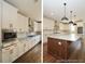 Bright kitchen with white cabinets, stainless steel appliances, granite countertops, and island with wood accent at 97 Fox Oak Trl, Pittsboro, NC 27312