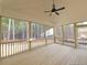 Outdoor screened porch with wood flooring and views of the surrounding trees at 97 Fox Oak Trl, Pittsboro, NC 27312