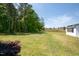 Expansive backyard with lush green grass and mature trees for privacy and outdoor enjoyment at 9947 Nc Hwy 96 N, Selma, NC 27576