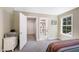 Neutral bedroom with doors to a closet and bathroom, featuring a large window at 9947 Nc Hwy 96 N, Selma, NC 27576